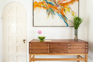 The entryway features similar arched doors and continues the style and color palette from the living room.