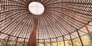The woven wood ceiling of the gallery houses Bello's wooden sculptures but is a piece of artwork in and of itself.