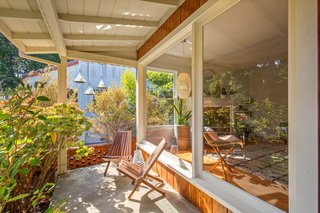 The front porch has just enough space for a seating area.