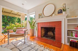 The living room also features a brick fireplace.