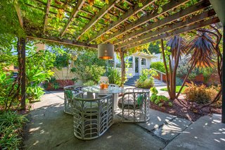 The kitchen opens out onto the backyard, complete with a pergola.