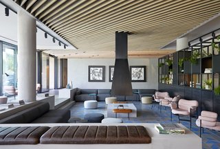A fireplace with a floating chimney is the central element of this part of the lobby.