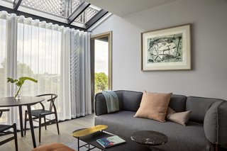 A look at the hotel's living room, which features floor-to-ceiling windows and modern furniture.