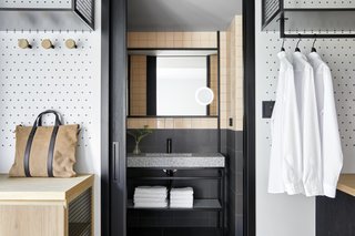 A guest bathroom is revealed with a sliding pocket door.