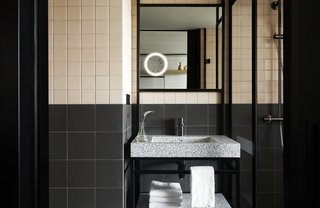 This bathroom features a new take on traditional two-toned square tiles.
