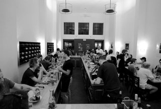 The central bar wraps around the dining space at Stellina in Marfa. The restaurant's interior design hearkens back to the minimalist designs of the artists that transformed Marfa into the renowned town it is today.