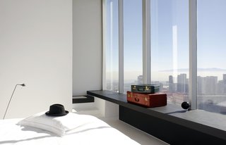 Minimalist glamour in the form of fine finishes, tall ceilings, large windows, and white walls are found at the Distrito Capital Hotel in Mexico City's skyscraper district, Santa Fe.
