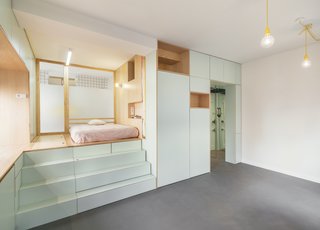 The two yellow hanging pendants contrast with the light green and hint at the punches of yellow also found in the bathroom.