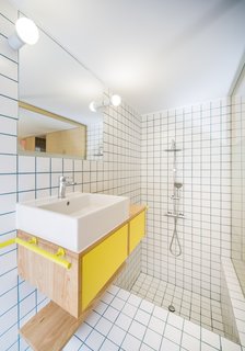 The tub and shower are sunken, reflecting the two levels in the rest of the apartment.