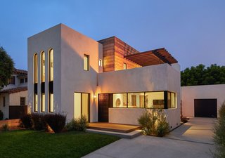 At night, the windows and second floor patio make the building glow.