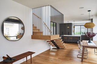 The dining area, stair, and living area are all open, allowing for strong sightlines across the ground floor.