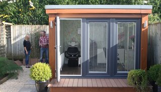 This modern garden shed, which measures about 9' x 9', was customized to function as a hair salon complete with hair sinks, salon chairs, and other equipment and furniture.