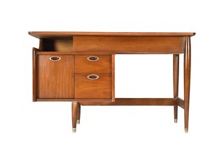 A cantilevering top and hanging drawers give this walnut desk the illusion of defying gravity.