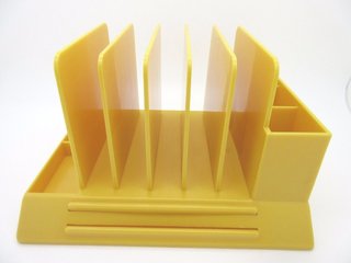 A bright yellow V-87 desk organizer by Max Klein