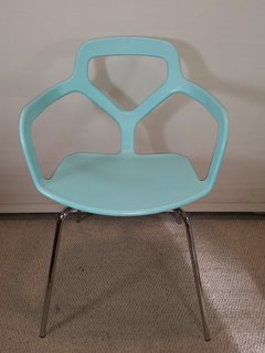 The playful transitions from solid to void and the bright turquoise color of this chair make it a great fit for homes that have a lot of neutrals.