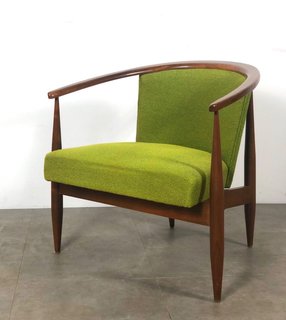 This barrel-backed armchair has clean lines and original lime green upholstery.