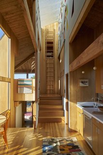 The wood cabinets, floor, structure, stairs, and wall paneling all work together in the interior of the Rush House, which keeps visitors from feeling consumed and overwhelmed by all the wood finishes because of great lighting, high ceilings, and large expanses of windows with views to the outdoors.