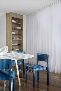 In the dining area, Billiani Design 'Blue' dining chairs from Hub Furniture are a bold but warm shade of blue that provides a welcome moment of contrast from the white walls and dining table. 