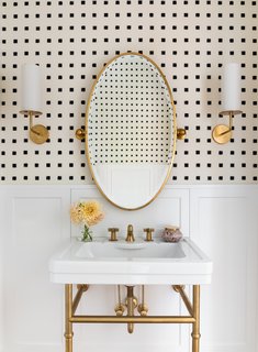The renovation of a 1925 residence for a growing family included the demolition of a powder room and the design of a new half bathroom on the ground floor of the Colonial Revival home.