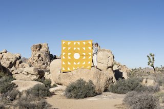 Through her company Vacilando Quilting Co., Laura Preston designs quilts, pillows, and canvas goods that employ traditional quilting methods with modern graphics.