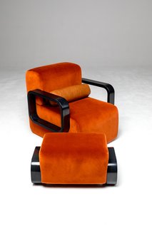 Harmony and balance are explored in Marie Burgos's designs, as seen in the contrast between the soft, plush fabric and hard, shiny frame of this chair; its bold, burnt orange tone is reminiscent of beach sunsets, in part inspired by her family's roots in the Caribbean.