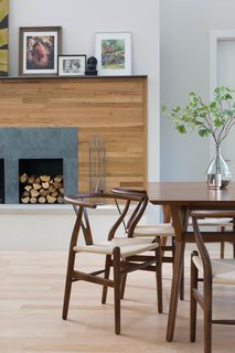 Q&A With an Architect About What it's Like to Design Your Own Home - Photo 3 of 7 - The wood used on the fireplace wall was salvaged from the floor of the old home that the architect and her husband lived in before eventually deciding to build a new home in its place. It was painstakingly salvaged, sorted, stripped, cut, and re-stained before finding new life as a wall finish.