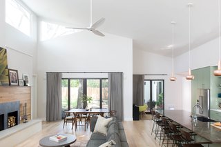 Q&A With an Architect About What it's Like to Design Your Own Home - Photo 2 of 7 - The open concept living/dining/kitchen has a large vaulted ceiling with rectangular and triangular clerestory windows that wash the space with tree-dappled natural light from high above. 