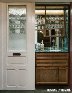 Few things scream old-world class more than a marble-topped bar. So is the case with this wet bar in a Park Slope duplex that's kept out of immediate view by two original sliding doors. The combination of green marble, custom new cabinetry, decorative-etched glass, and original woodwork creates a space that oozes glamour, while the doors keep the space feeling neat and tidy.