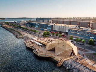 This waterfront sauna by Avanto Architects features a louvered skin system, exposed steel, and planks that cast linear shadows onto the sauna's structure.