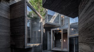 6 Well-Designed Hostels For the Minimalist Traveler - Photo 4 of 6 - Intended to be sympathetic to the divergent qualities of the aging city, Zhang Ke added a series of staggered rooms with an unfinished, misshapen concrete finish. 