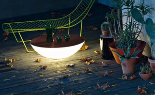 Designed by Jean-Marie Massaud for Foscarini, this outdoor light also acts as a surface to place drinks on or gather around.