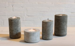 These industrial candleholders were made with a concrete mix that was casted in plastic water bottles. DIY designer Ben Uyeda of HomeMade Modern layered in different colors of concrete to create a fading, ombre effect. 