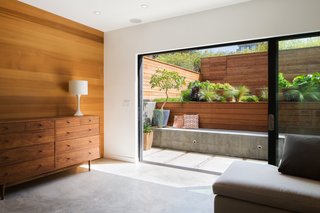 Revamping the San Francisco Vernacular, Modern Design and Technology Serves A Busy Family - Photo 6 of 7 - The downstairs family room serves as a guest room for visiting family, the kids’ play area and art studio, movie-watching room, and indoor/outdoor living room. 