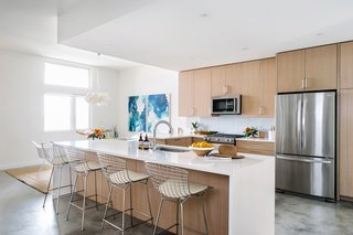 Knoll's Bertoia counter stools were chosen to complement the hardware in the kitchen. 