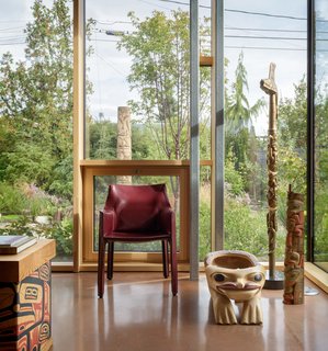 Inspired by the red cedar and ochre colors in the client's extensive Native American art collection, the architects tinted the concrete floors with a custom red hue.
