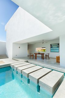 10 Modernist Beach Home Rentals to Escape to This Summer - Photo 5 of 10 - Designed by Campos Leckie to invoke a pure, dream-like quality, this minimalist retreat is situated on a hill above Zippers Beach overlooking the Sea of Cortez. The bold geometric angles, stripped down interior, and whitewashed walls allow for maximum light and shadow play throughout the day. The home features a Zen garden, central pool, and a rooftop patio with sweeping views of the ocean and mountains.