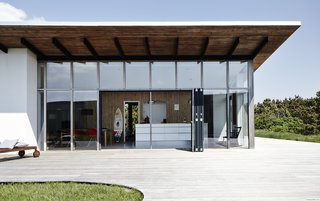 10 Modernist Beach Home Rentals to Escape to This Summer - Photo 7 of 10 - Located on the western Danish coast within walking distance of the North Sea, this home was designed by Soren Sarup to integrate elements of the surrounding landscape and to highlight natural, contemporary beauty. The interior fuses clean-lined simplicity, an abundance of wood surfaces, and a restrained mix of Danish-modern and vintage furniture to create a visually stimulating yet relaxing environment that extends between indoor and outdoor living spaces. 