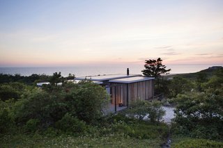 10 Modernist Beach Home Rentals to Escape to This Summer - Photo 8 of 10 - Originally designed by Jack Hall in the 1960s for Robert Hatch, an editor of The Nation and his wife, the "experimental cottage" is actually a series of separate cubes that are connected to a large central living area via outdoor decks—constructed in such a way that the cottage looks as though it's floating slightly above ground. The home is designed with sweeping views of the Outer Cape and is near some of the highest-rated beaches in the continental U.S. 