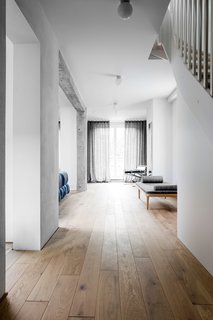 A Family’s Loft in Poland Gets a Minimalist Renovation That’s Both Elegant and Functional - Photo 3 of 12 -