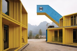The Qiyun Mountain Camp is an extreme sports and adventure park that sits on a 60-acre property in China. LOT-EK designed the public facilities and services within the park, which includes a 15,000-square-foot restaurant plaza that overlooks a river.