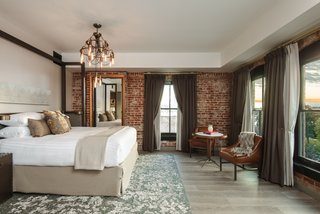 Guests can enjoy plush, comfortable bedding in each room, along with exquisite exposed brick.
