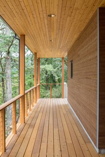 Boards, Battens, and Bevels: Wood Board Siding Types and Their Uses - Photo 6 of 9 - Indented channels of the oak overhang contrast with the smooth surface of the horizontal planes of the house.