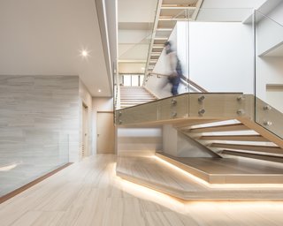 The architect, EKAR, says that "each floor of the house features different materials, such as wood, stone-texture coated wall, and stone-like tiles. This material combination creates a uniqueness to the facade which still fits into the surrounding context."