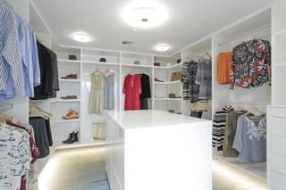 10 Modern Walk-In Closets - Photo 4 of 10 - This renovated post-and-beam estate from 1956 is a shining example of modern minimalism. The luxurious master bedroom is completed with a bright walk-in closet.