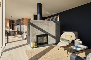 In the living room, the design team poured concrete in place using smooth board formwork to create the seamless fireplace. 
