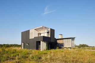 Floor-to-ceiling sliding doors open to the great outdoors, and industrial-grade metal screens keep bugs from entering and provide protection for those standing up against windows.
