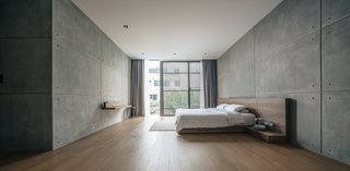 Recessed lighting is strategically placed along the edges of this expansive, minimalist bedroom in Thailand. For master bedroom ceiling lighting ideas where a clean look is desired, recessed lighting makes a great option. 