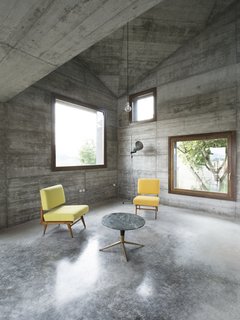 25 Modern Homes That Kill it With Concrete - Photo 21 of 25 - An Italian architecture studio offers an updated take on the vacation cabin. It's an ideal setting for a getaway: rolling hills dotted with villages and castles in Italy's Oltre Po Pavese region. A young Milanese couple wanted a small vacation home on their 3000-square-meter lot there—and 35a Studio delivered, by way of this 120-square-meter cabin decked out in textural concrete and strategically accented with wood.