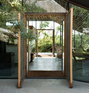Views from the main living area focus on the surrounding vegetation. "Instead of placing the house on the spot with the best view, it is situated in a way that is tailored to the specific terrain, and gives prominence to the views from the outdoor room," writes Lung Hagem Arkitekter.