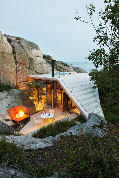 Lung Hagem Arkitekter says, "The roof is executed in 270-millimeter-thick reinforced concrete with 20-millimeter VIP insulation underneath. The concrete itself is water resistant, thus no additional roofing materials are required. As a result, the roof is a smooth, white surface creating a dialogue with the rocky landscape, and giving the cabin its distinctive character."